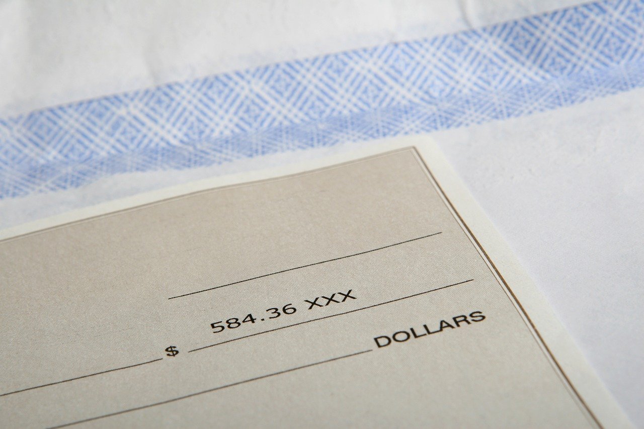 A paper check on an open envelope