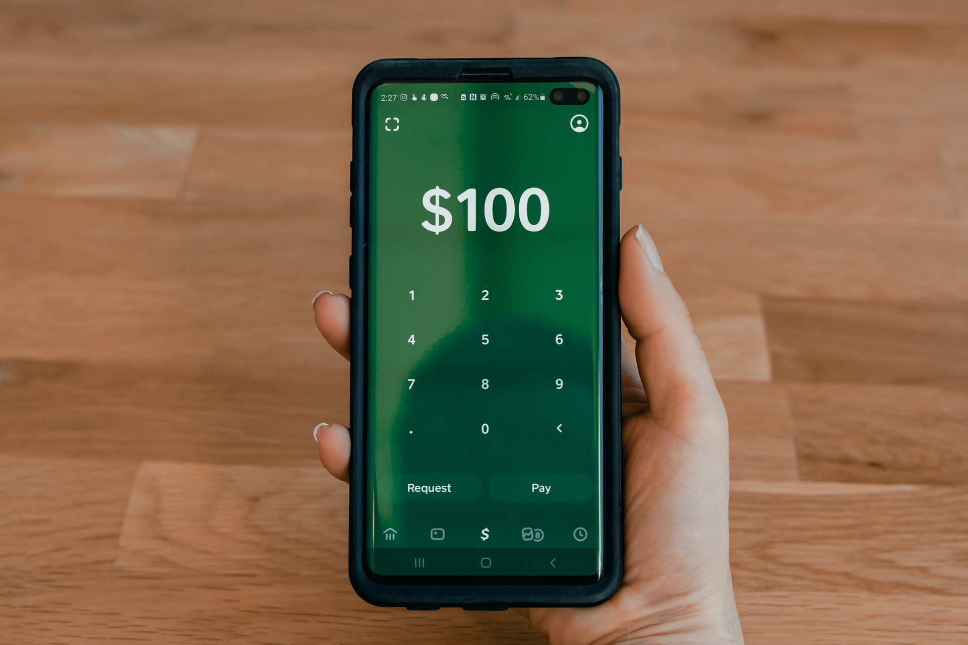 Cell phone showing 100 dollars processed through eCheck verification