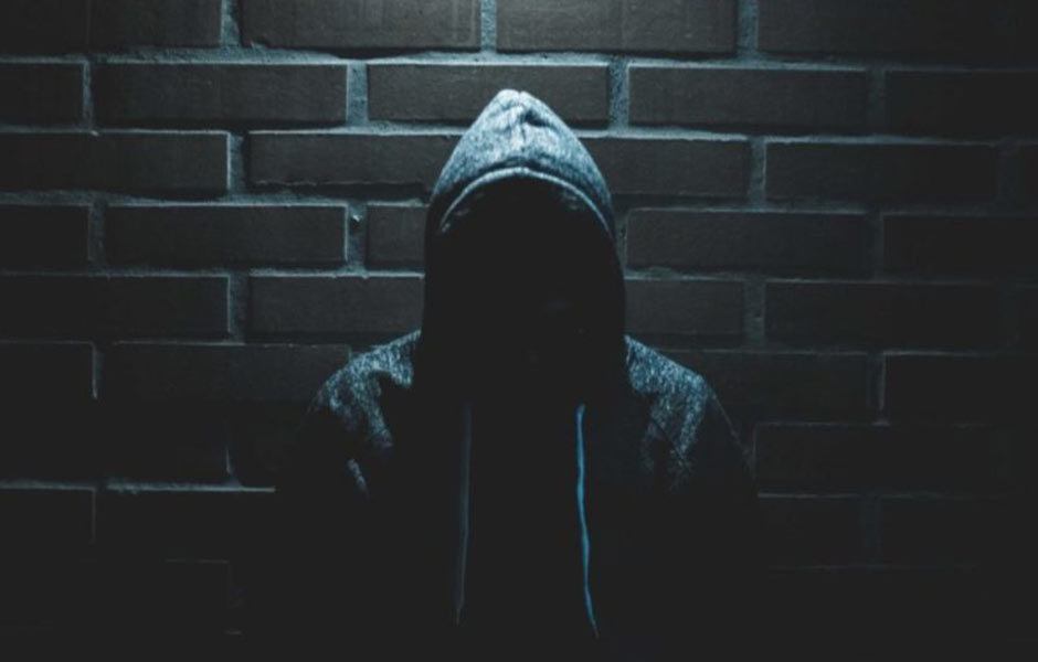 Hooded Man in Dark Lighting